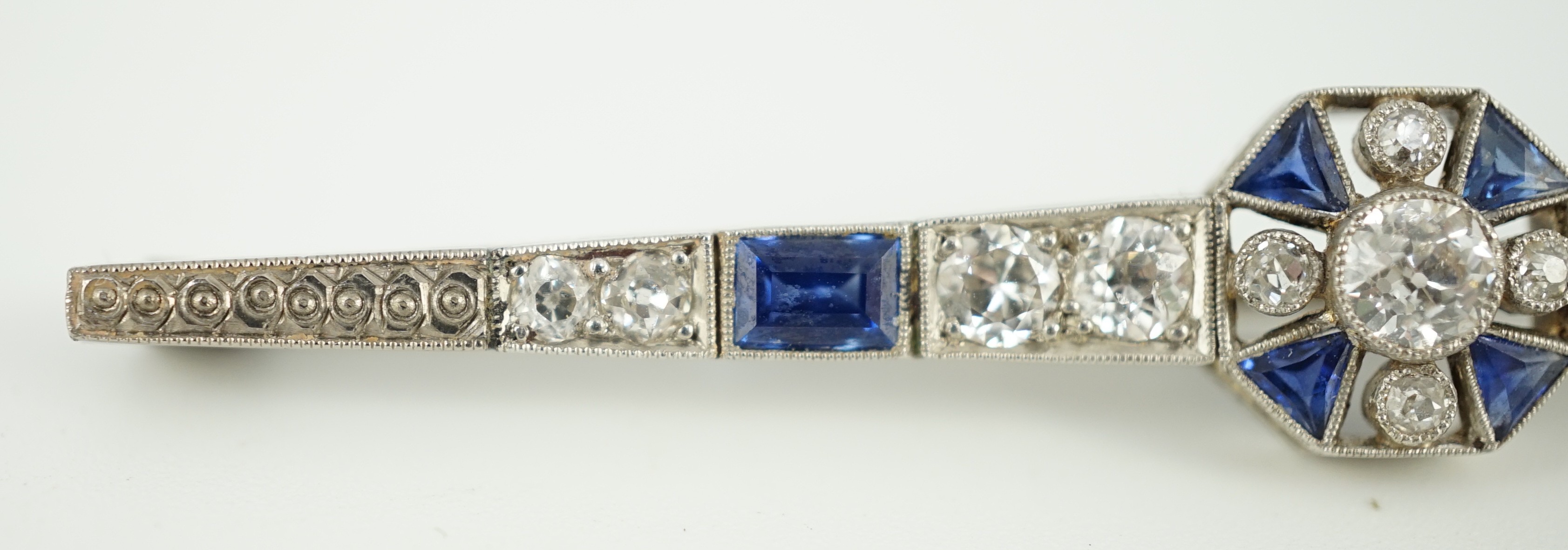 A 1920's/1930's white gold, sapphire and diamond cluster set bar brooch